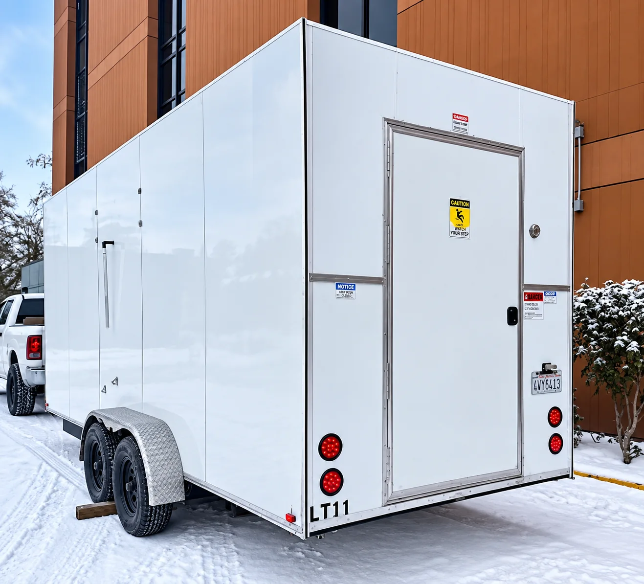 Exterior side view of a white refrigerated trailer